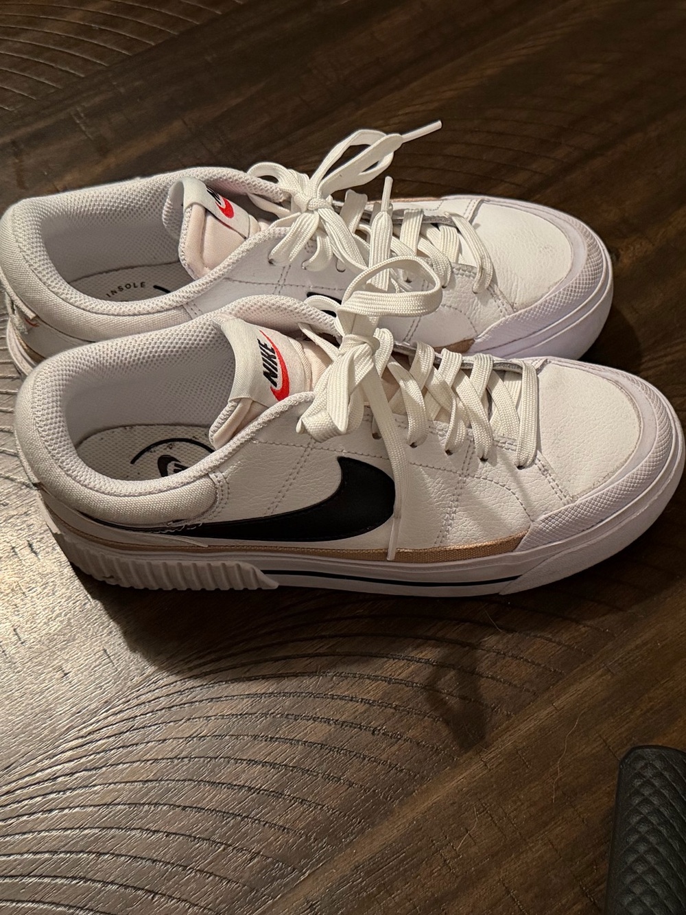 Nike Women’s White Sneakers with Black Swoosh and Gold Accent